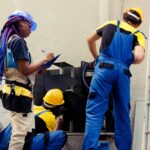 HVAC technician checking air filter during AC maintenance service