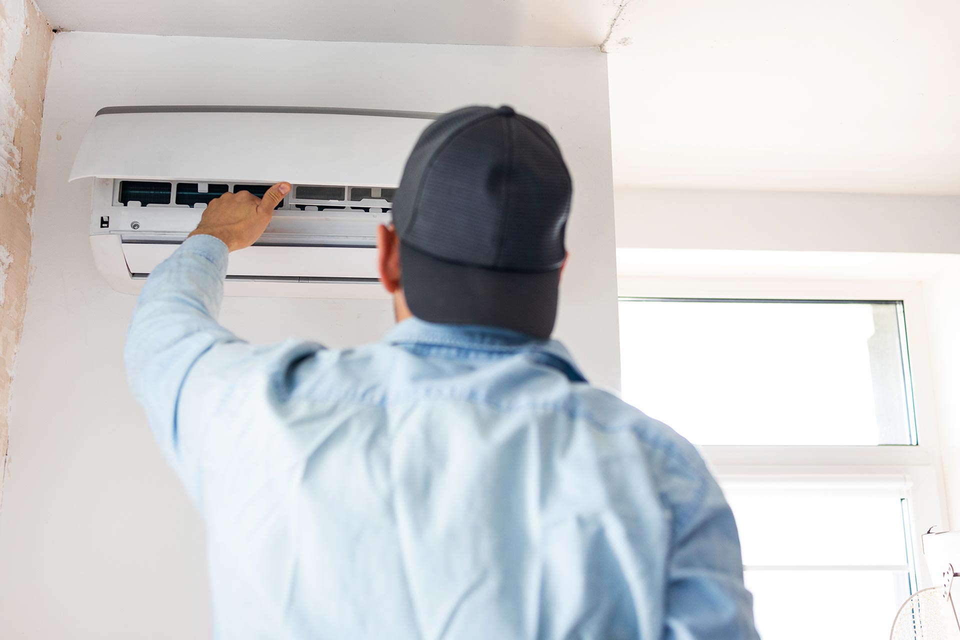 HVAC technician repairing an air conditioner for an Ocala homeowner before summer heat gets worse