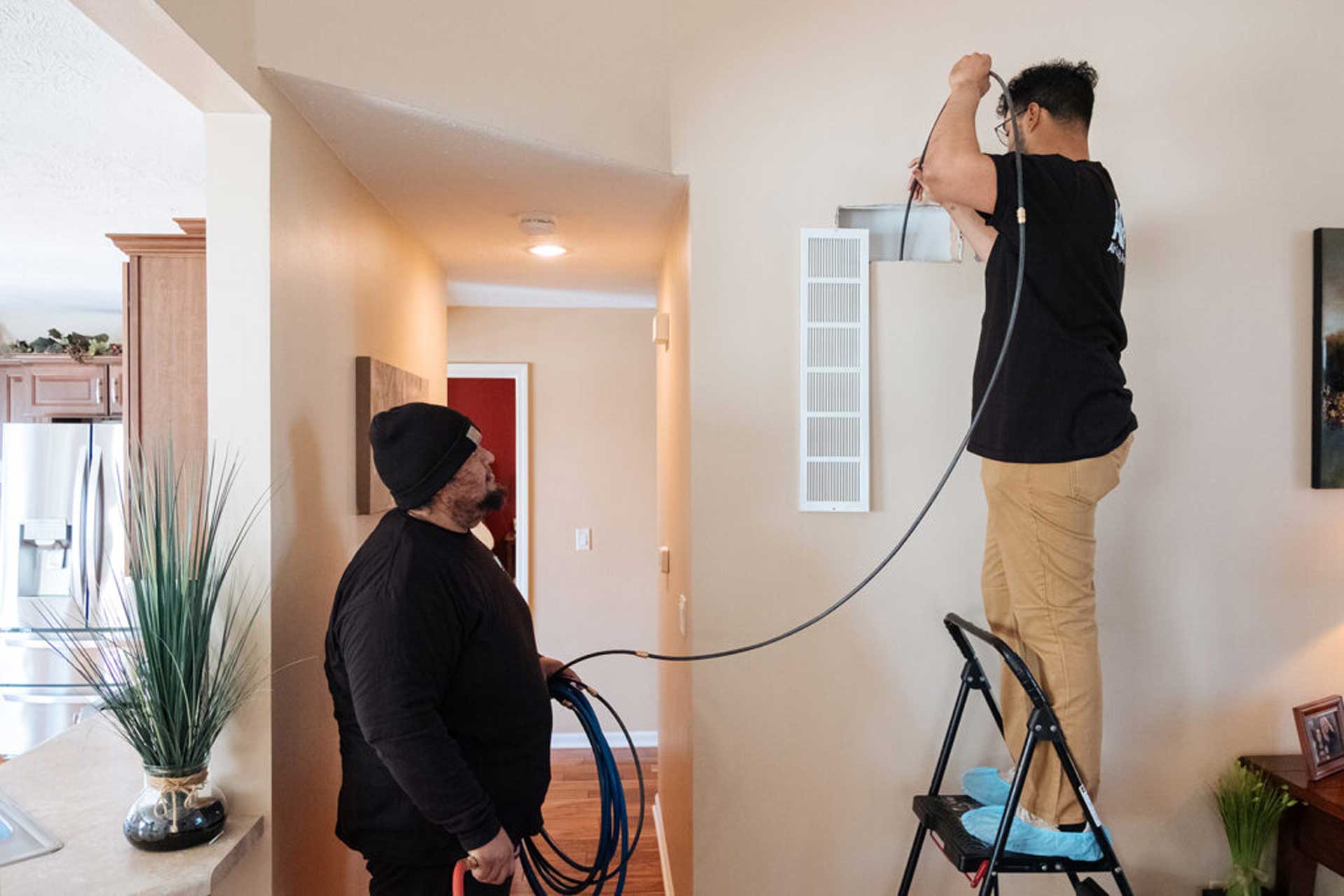 Wingman Heating and Cooling technician cleaning air duct