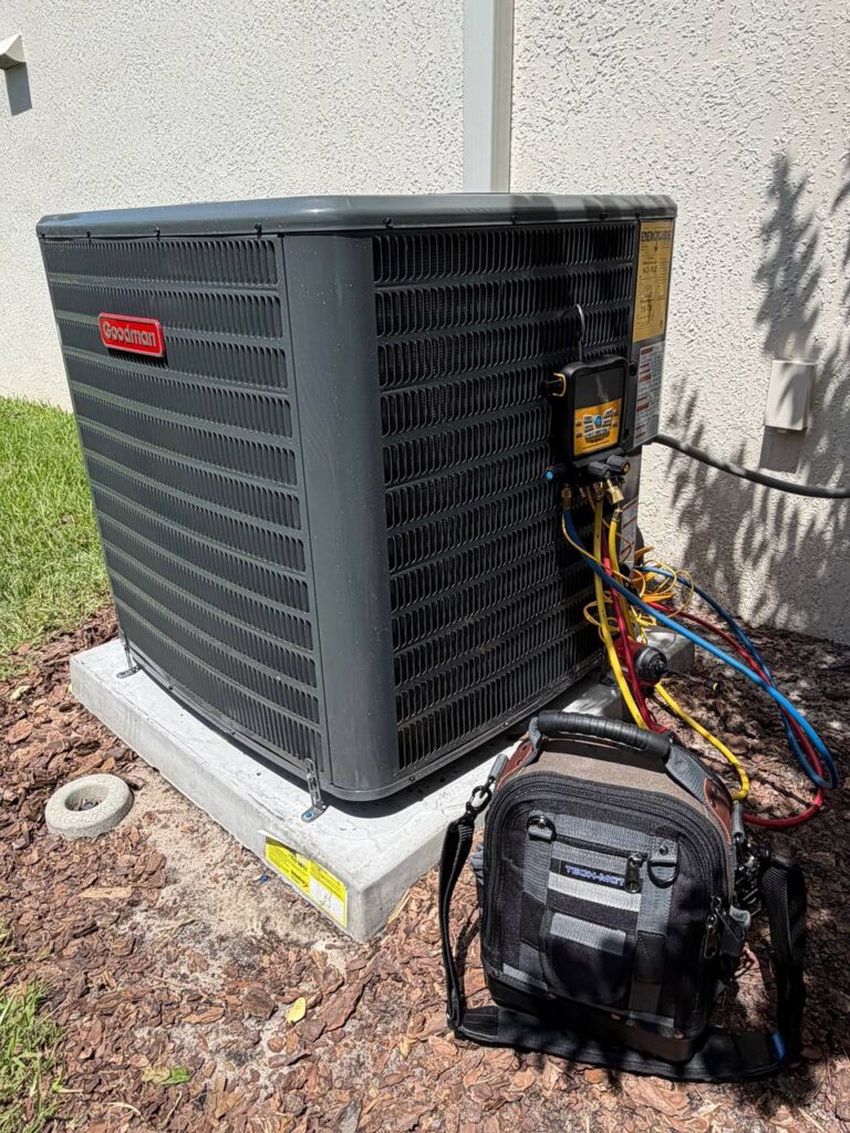 Wingman HVAC technician checking an outdoor AC unit during service in Central Florida