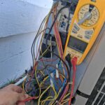 Wingman HVAC technician diagnosing an AC system before repair or replacement